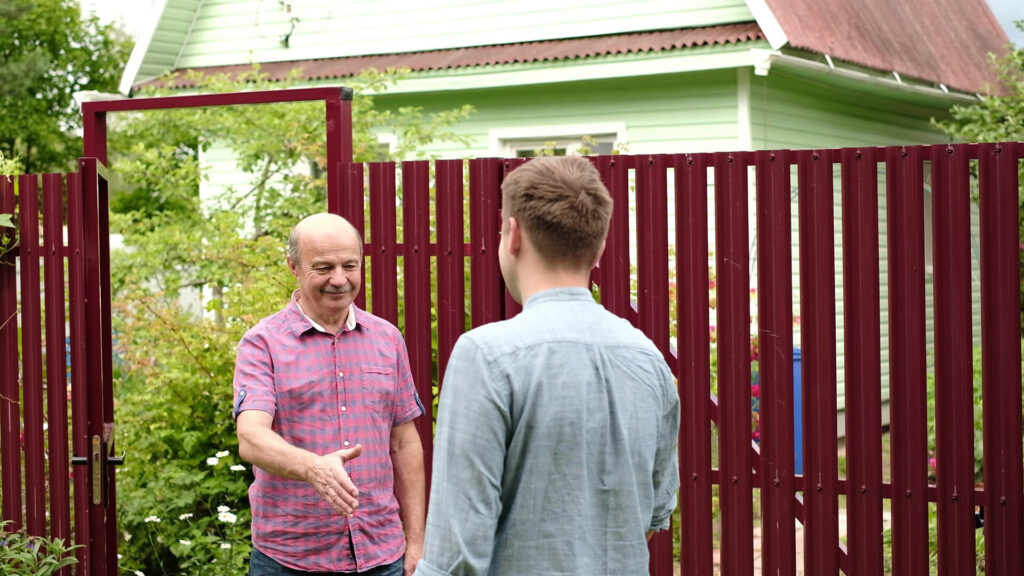 Testimonials Two Men Shaking Hands In Front New Fence
